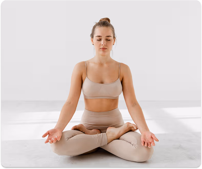 A woman meditating calmly in a bright, peaceful space